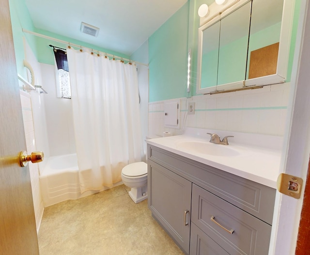 full bathroom featuring tile walls, vanity, toilet, and shower / tub combo