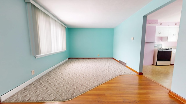 spare room featuring light wood-type flooring