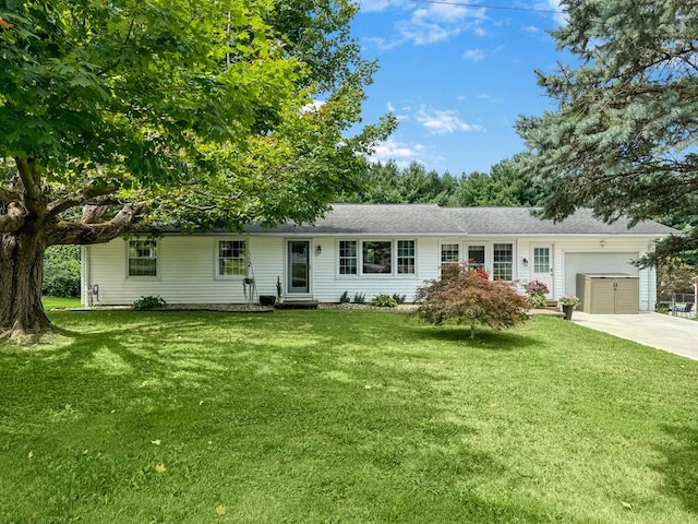 single story home with a garage, driveway, a front yard, and entry steps