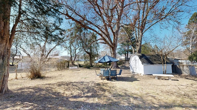 view of yard featuring a fenced backyard, a storage shed, and an outdoor structure