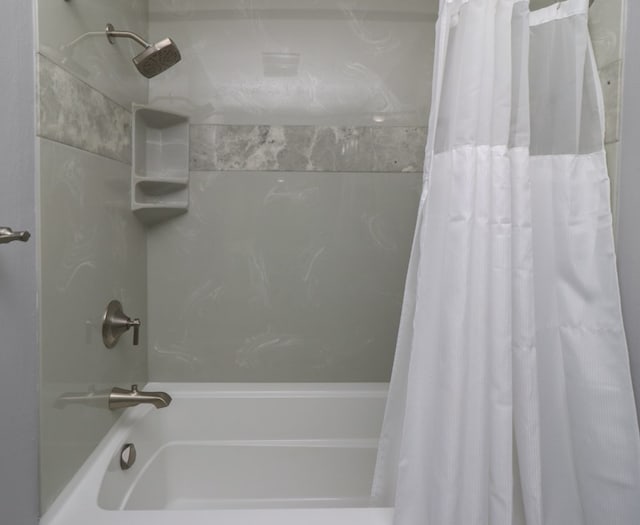 bathroom with shower / bath combo with shower curtain