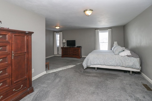 carpeted bedroom featuring visible vents and baseboards