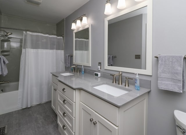 bathroom featuring toilet, shower / tub combo with curtain, a sink, and double vanity