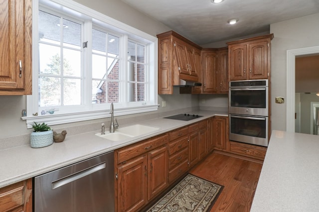 kitchen with plenty of natural light, light countertops, a sink, and appliances with stainless steel finishes