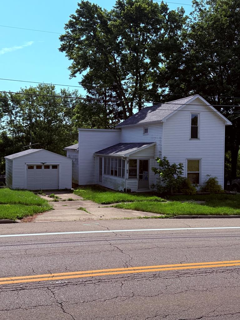 69 Frederick St, Lexington, OH 44904 - traditional-style home with an outdoor structure, a detached garage, and driveway
