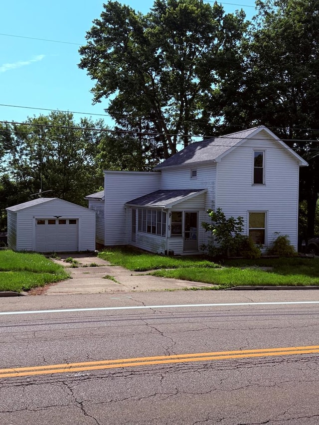 69 Frederick St, Lexington, OH 44904 - traditional-style home with an outdoor structure, a detached garage, and driveway