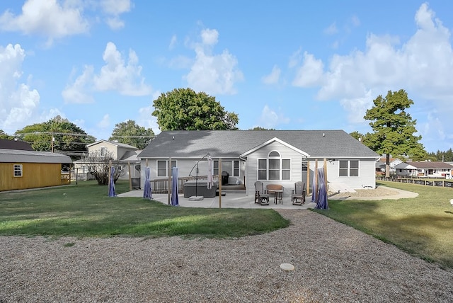 rear view of property featuring a yard and a patio