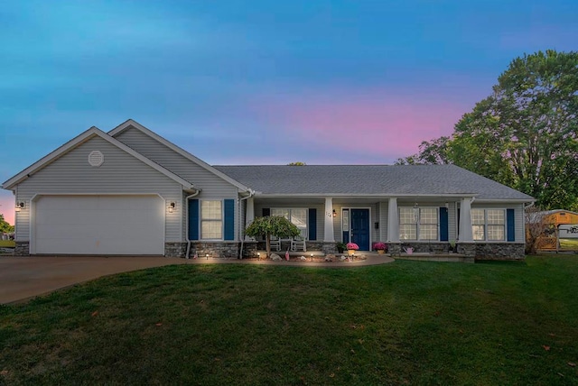 ranch-style house with a yard and a garage