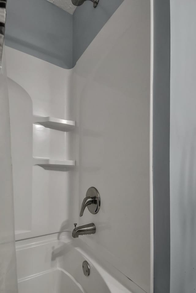 bathroom with shower / washtub combination