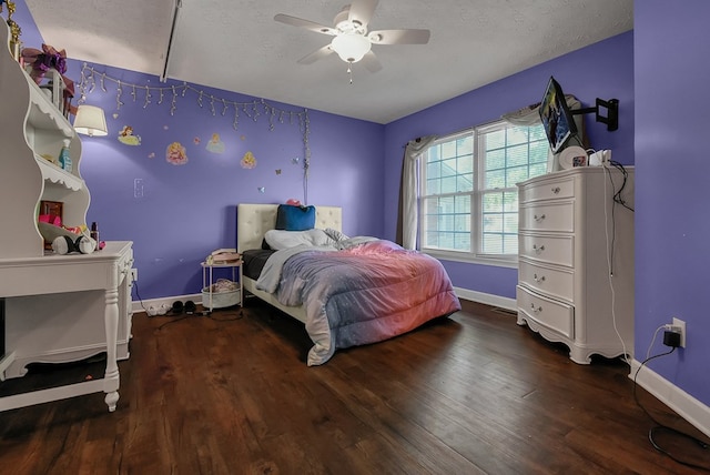 bedroom featuring ceiling fan, dark hardwood / wood-style floors, and a textured ceiling