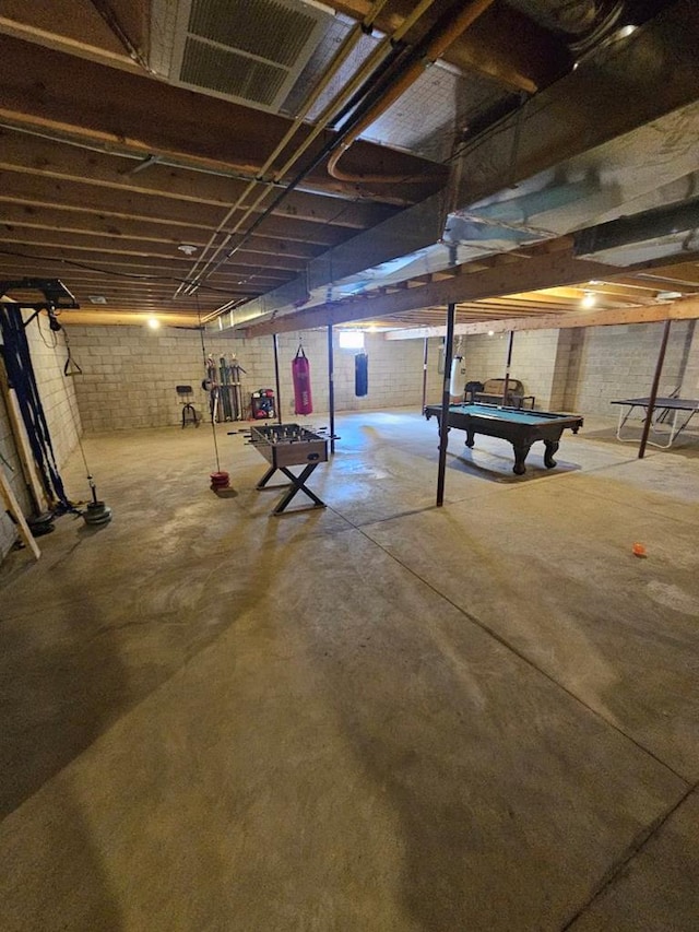 basement featuring brick wall and pool table