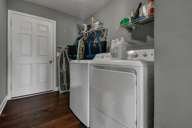 washroom featuring washer and dryer, a textured ceiling, and dark hardwood / wood-style floors