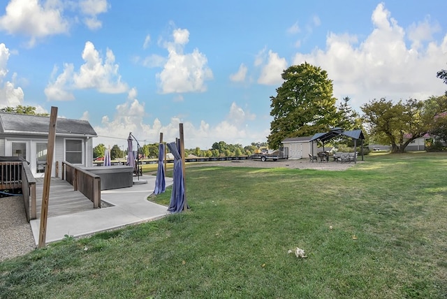 view of yard with a patio and a hot tub