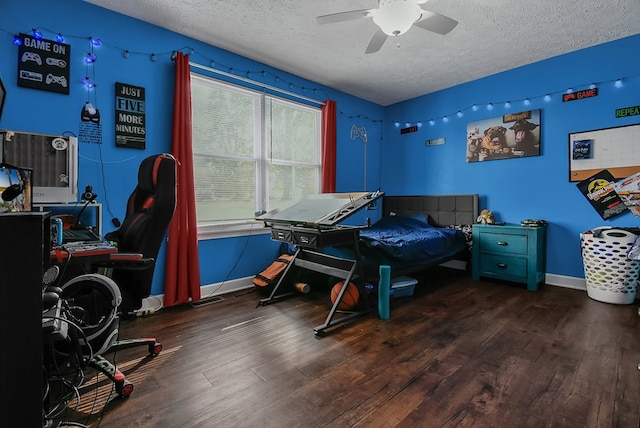 office area featuring a textured ceiling, dark hardwood / wood-style floors, and ceiling fan