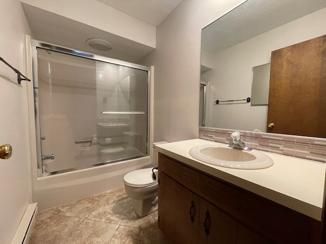 71 Taft St, Shelby, OH 44875 - full bath featuring baseboard heating, vanity, toilet, bath / shower combo with glass door, and tile patterned floors