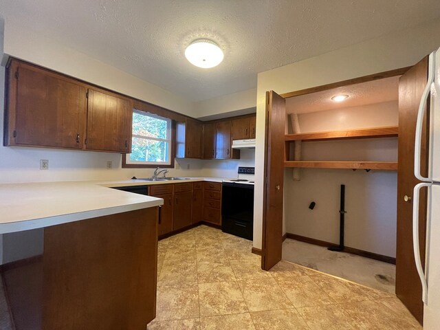 71 Taft St, Shelby, OH 44875 - kitchen with electric range oven, a peninsula, light countertops, under cabinet range hood, and a textured ceiling