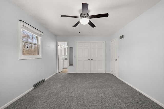 unfurnished bedroom featuring visible vents, baseboards, and carpet flooring