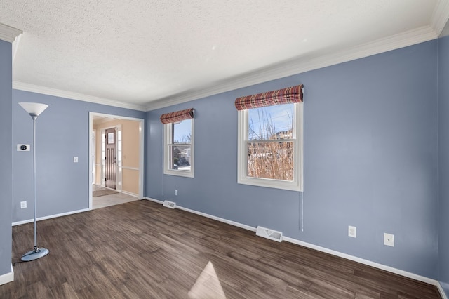 unfurnished bedroom featuring visible vents, a textured ceiling, wood finished floors, and ornamental molding