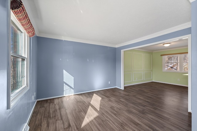 unfurnished room featuring a wealth of natural light, baseboards, and wood finished floors