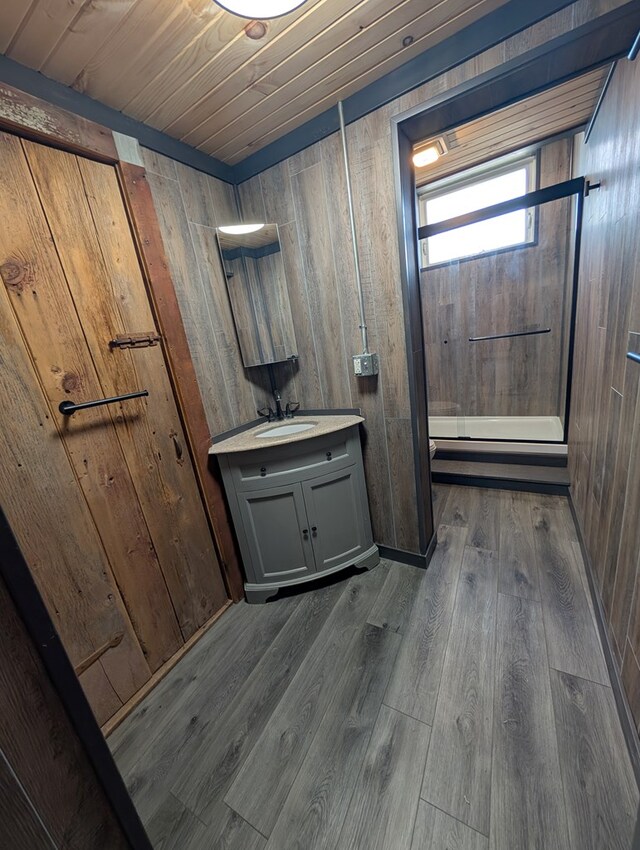 115 N Main St, Mount Gilead, OH 43338 - full bathroom featuring vanity, wood walls, wooden ceiling, a shower stall, and wood finished floors