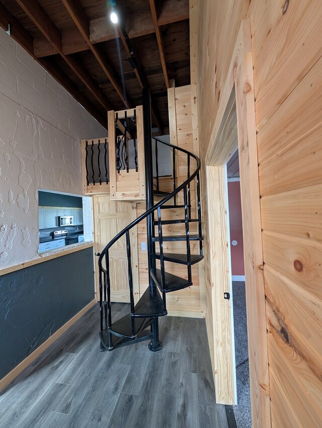 115 N Main St, Mount Gilead, OH 43338 - staircase with a textured wall and wood finished floors