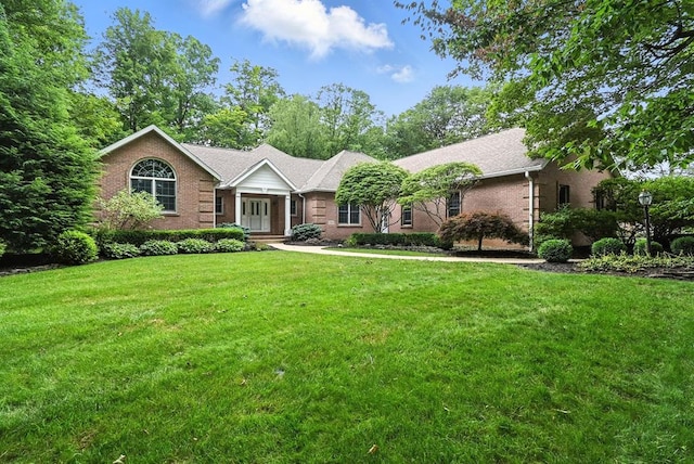 2323 Forest Hill Cir, Ontario, OH 44903 - ranch-style home featuring a front yard and brick siding