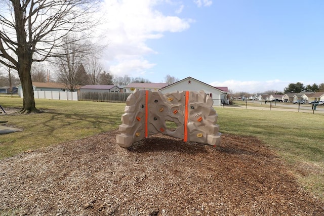 exterior space with fence and a lawn