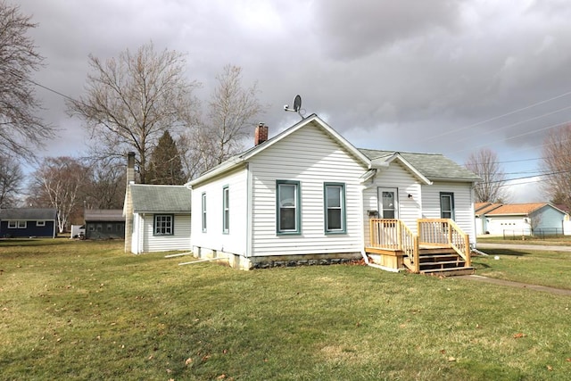 view of front of house featuring a chimney and a front yard