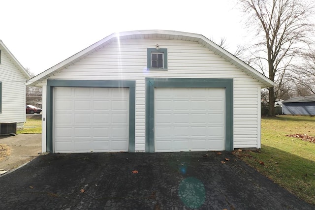 detached garage featuring central AC unit