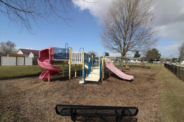 communal playground with fence and a yard