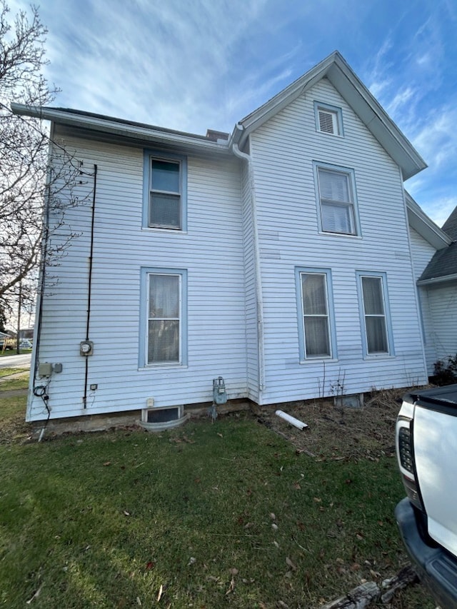 view of side of property with a yard