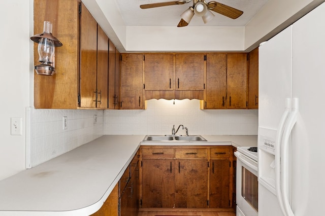 kitchen featuring sink, white appliances, ceiling fan, and backsplash