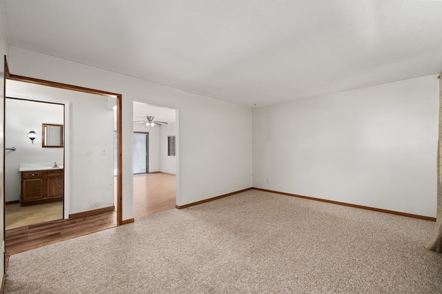 unfurnished room featuring sink and light colored carpet