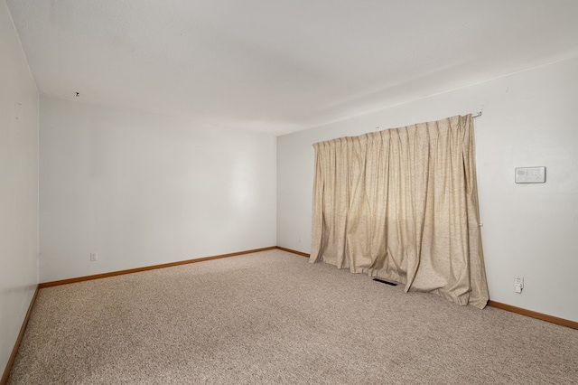 spare room featuring carpet floors