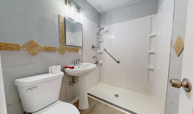 bathroom featuring toilet, hardwood / wood-style floors, and walk in shower