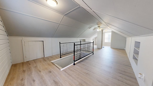 additional living space featuring lofted ceiling and light hardwood / wood-style flooring