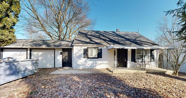 single story home with a garage, a patio, and covered porch