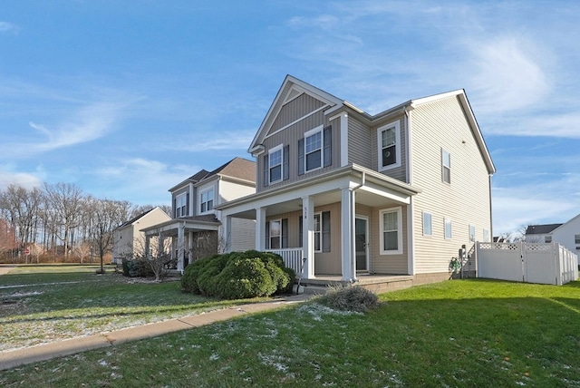 view of front of home with a front yard and a porch