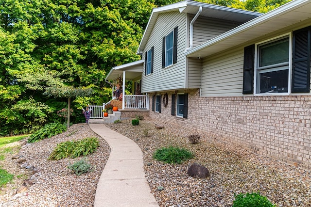 view of property exterior featuring covered porch