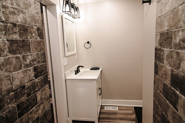 bathroom with hardwood / wood-style floors and vanity