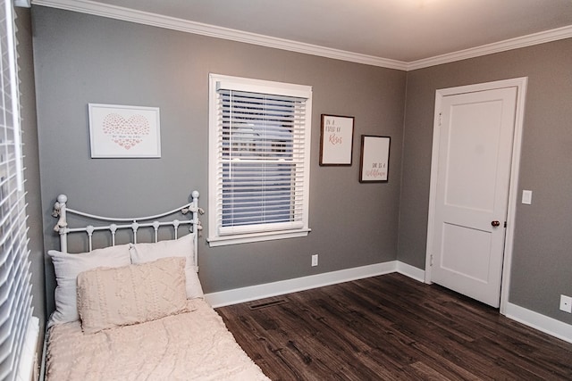 bedroom with dark wood-type flooring and crown molding