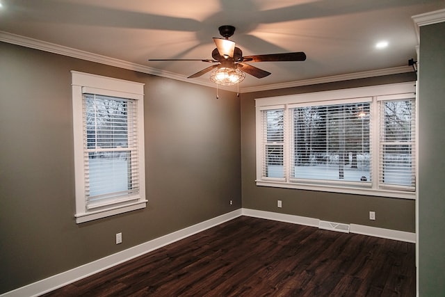 spare room featuring ceiling fan, dark wood-type flooring, and ornamental molding