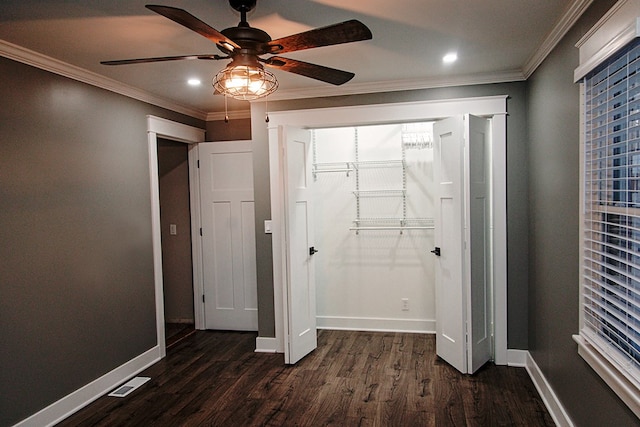 unfurnished bedroom with ceiling fan, ornamental molding, a closet, and dark hardwood / wood-style floors