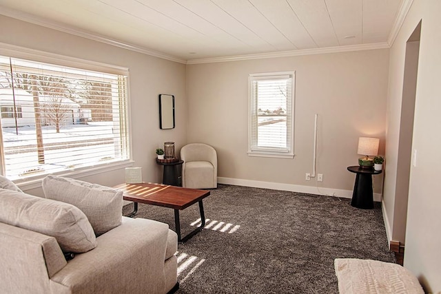 living area with a healthy amount of sunlight, dark carpet, and ornamental molding