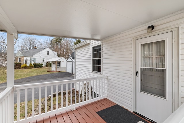 deck with a yard and an outbuilding