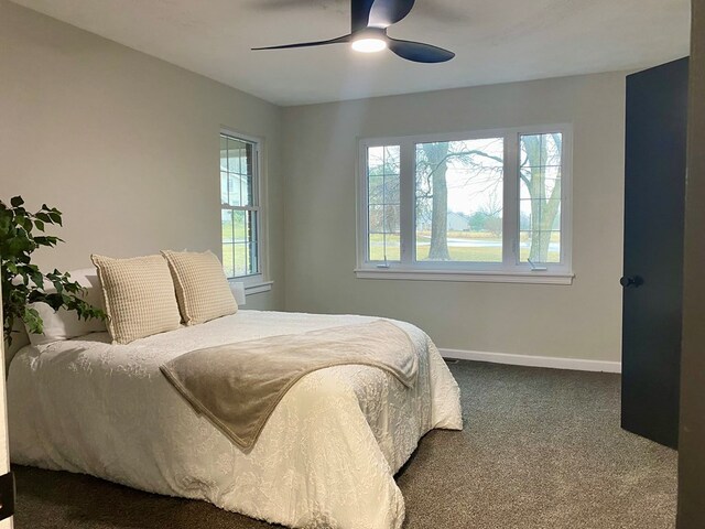 carpeted bedroom featuring a ceiling fan and baseboards
