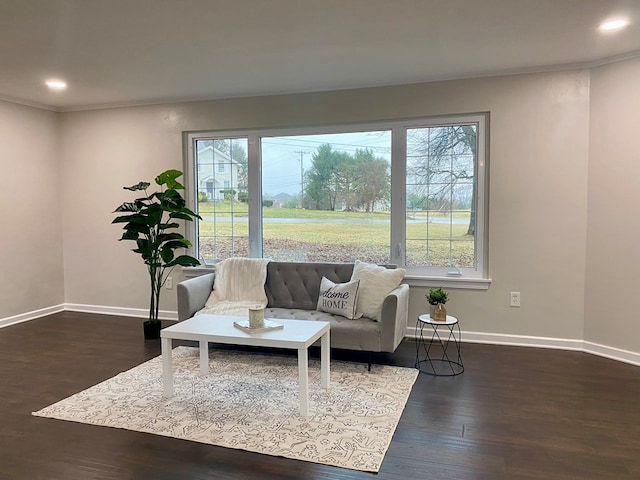 living room featuring recessed lighting, crown molding, baseboards, and dark wood-style flooring