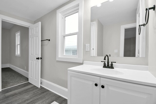 44 W 4th St, Fredericktown, OH 43019 - bathroom with vanity, wood finished floors, and baseboards