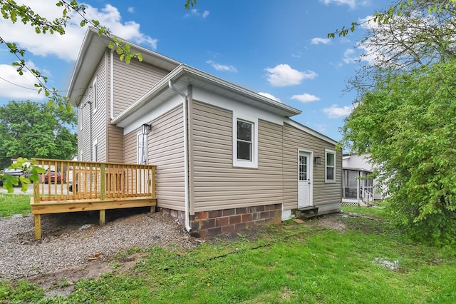 44 W 4th St, Fredericktown, OH 43019 - back of house with a wooden deck, a sunroom, and a yard