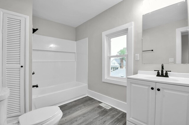 44 W 4th St, Fredericktown, OH 43019 - bathroom with toilet, wood finished floors, vanity, shower / washtub combination, and a closet